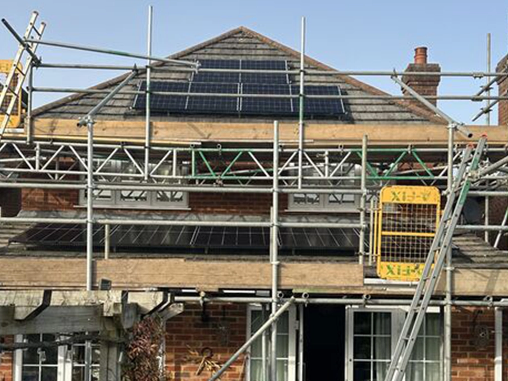 Solar panels being installed on a house roof – home solar PV installation
